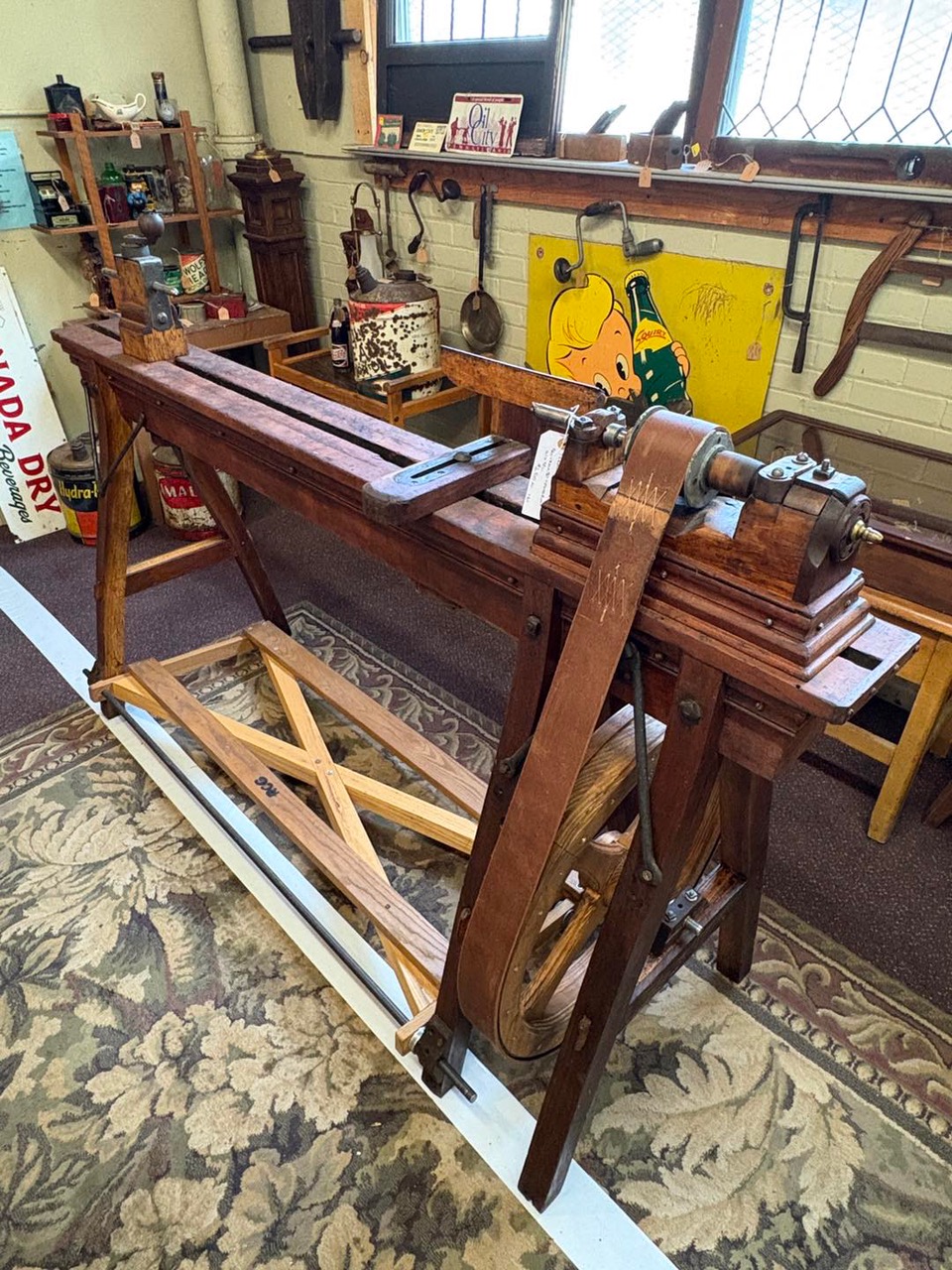 Beautifully restored antique wood lathe, expertly updated by a master craftsman—showcasing fine joinery, hand-turned details, and functional elegance for woodworking collectors or shop display.