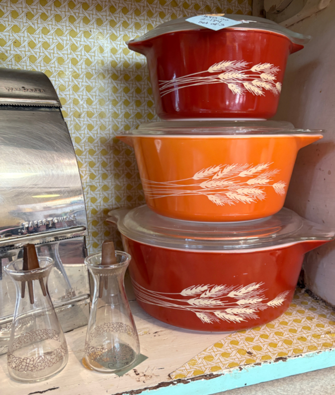Vintage Pyrex Wheat pattern casserole dish set with clear glass lids, featuring bold orange and red colors. Classic mid-century kitchenware collectible, perfect for cooking, serving, or retro farmhouse décor